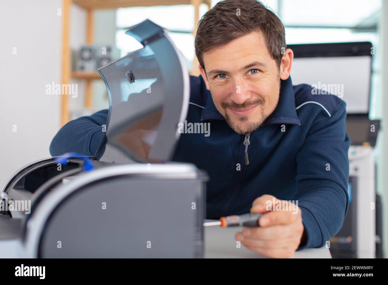 repairman repairing broken printer fax machine Stock Photo Alamy