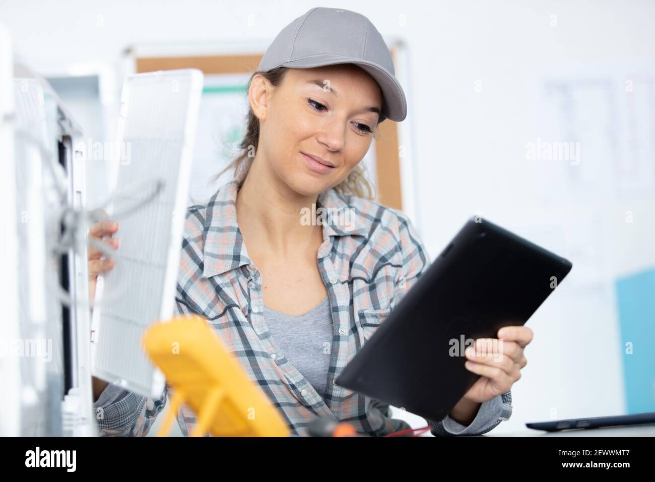 young woman checking data on digital tablet Stock Photo