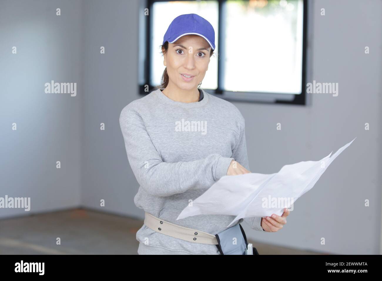 a female enginer checking plans Stock Photo