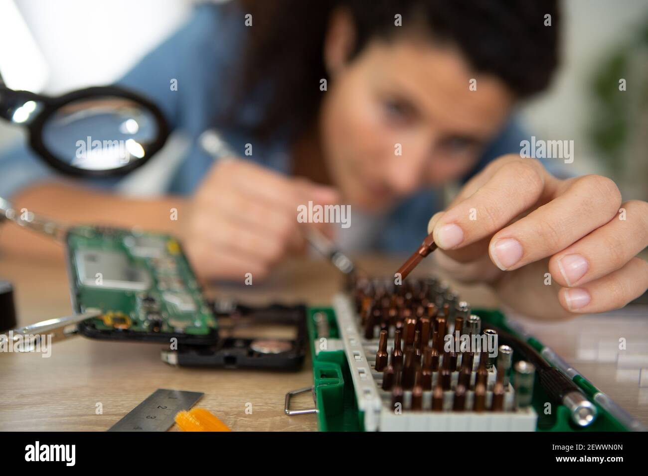 woman trying to find problem in motherboard of computer Stock Photo - Alamy