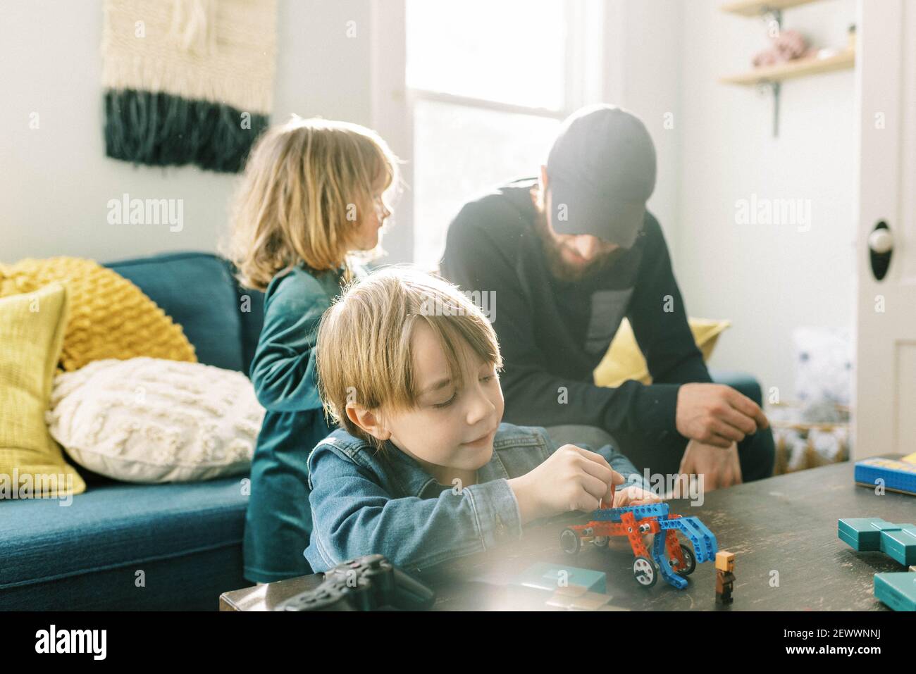 savvy little boy playing with construction toys in the family room Stock Photo