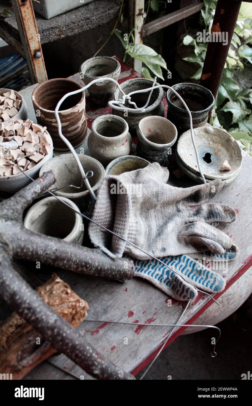 Clay products on the table of the master in the pottery workshop Stock Photo