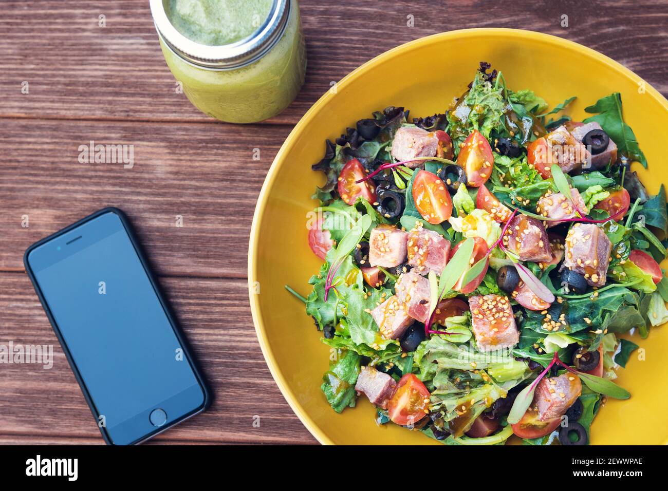 Tuna salad on wooden table. Concept of healthy food, space for text Stock Photo