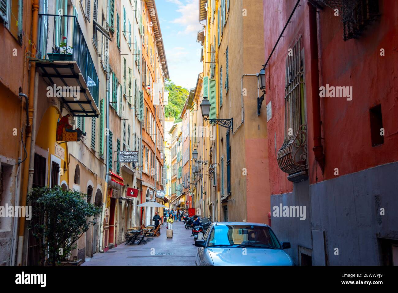 One of the many narrow alleys with high walls of apartments and shops