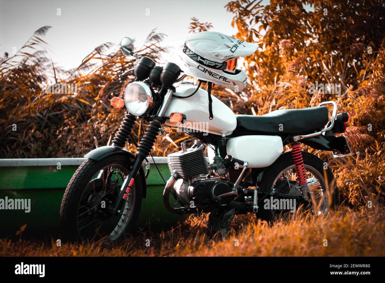 MALCHOW (MüRITZ), GERMANY - Jun 12, 2019: A white motorcycle (MZ ETZ 150ccm); Retro motorbike; with high contrast against the backround; staying at th Stock Photo