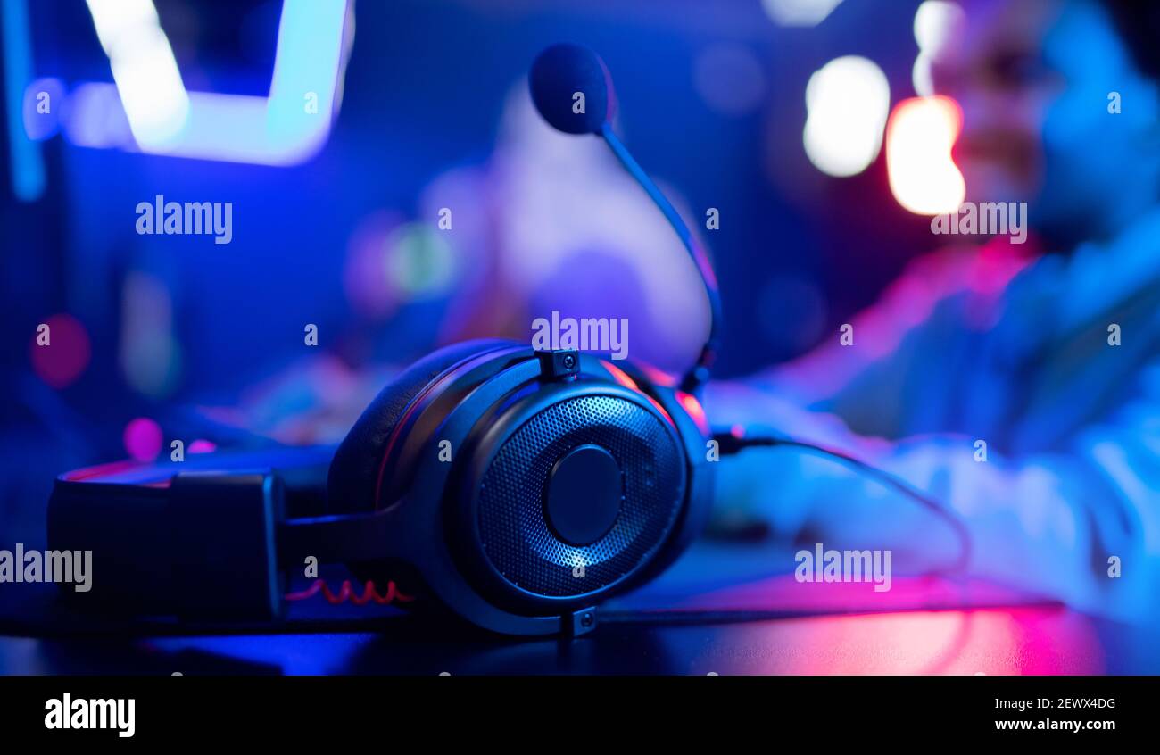 Banner professional headphones with microphone for video games and cyber  sports on background of gaming monitor Stock Photo - Alamy