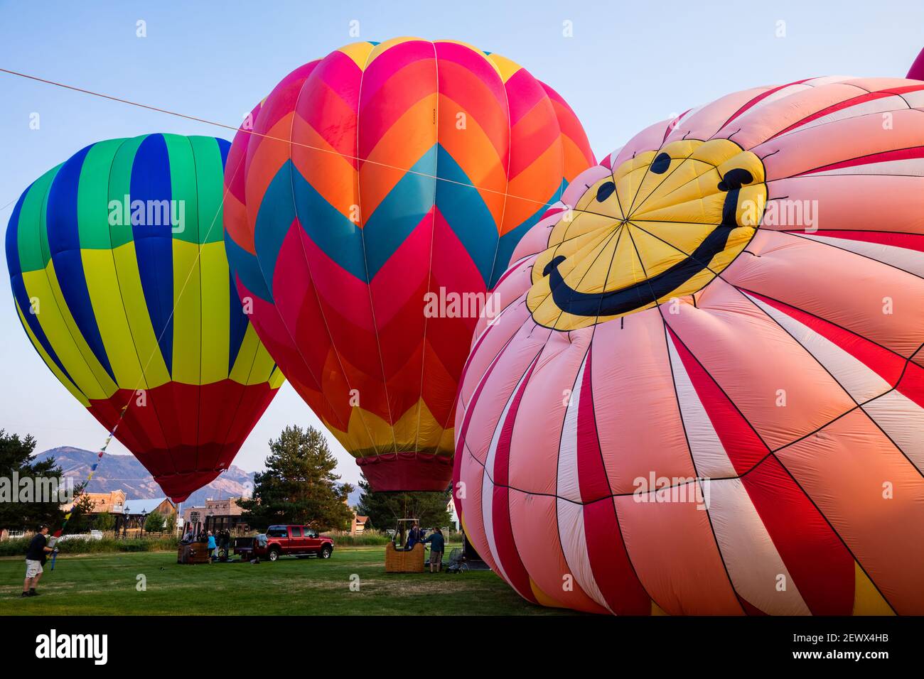 Hot air balloons being inflated including smiley face, Ogden Valley