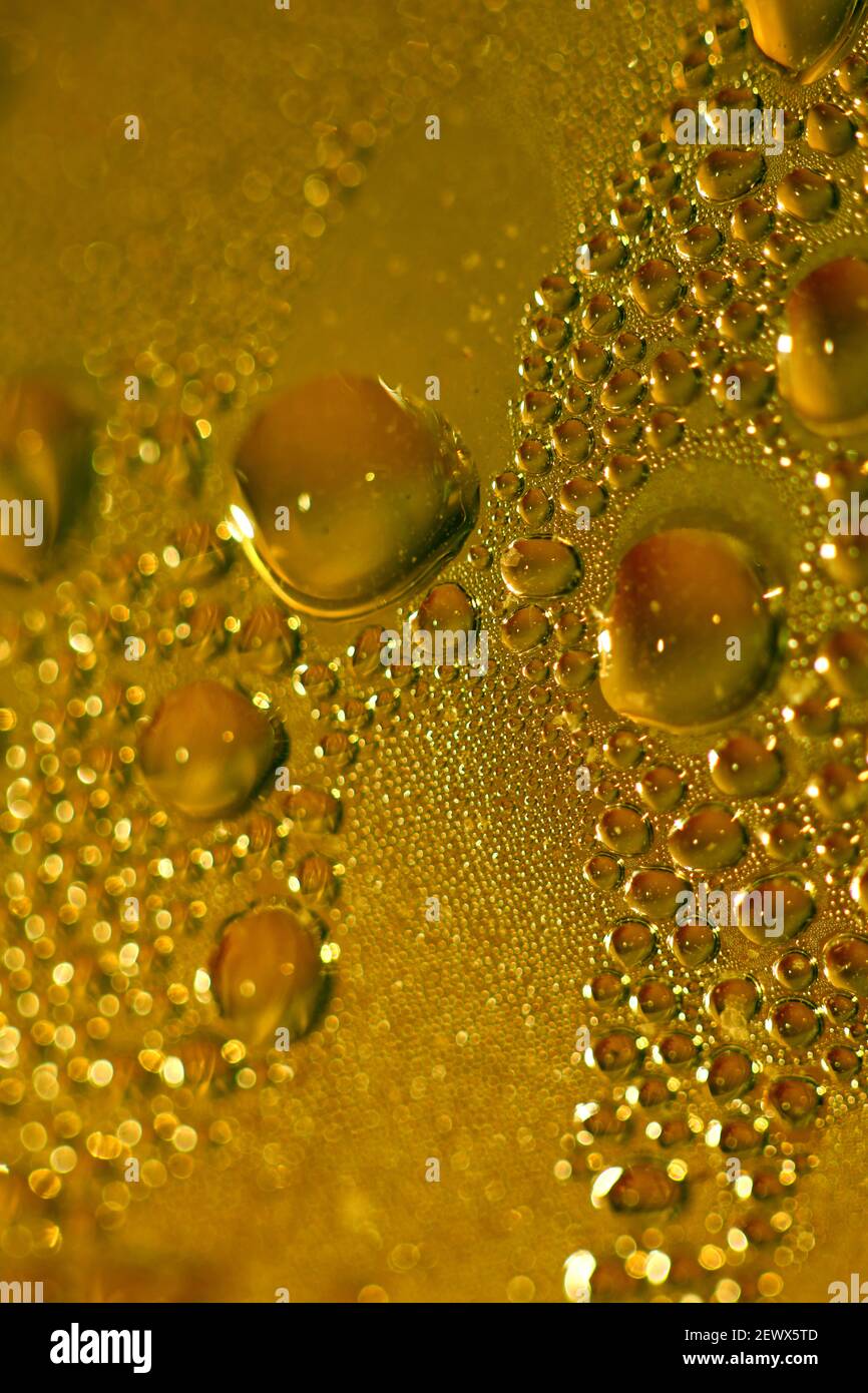 Macro shooting of water droplets beside the glass surface close up ...