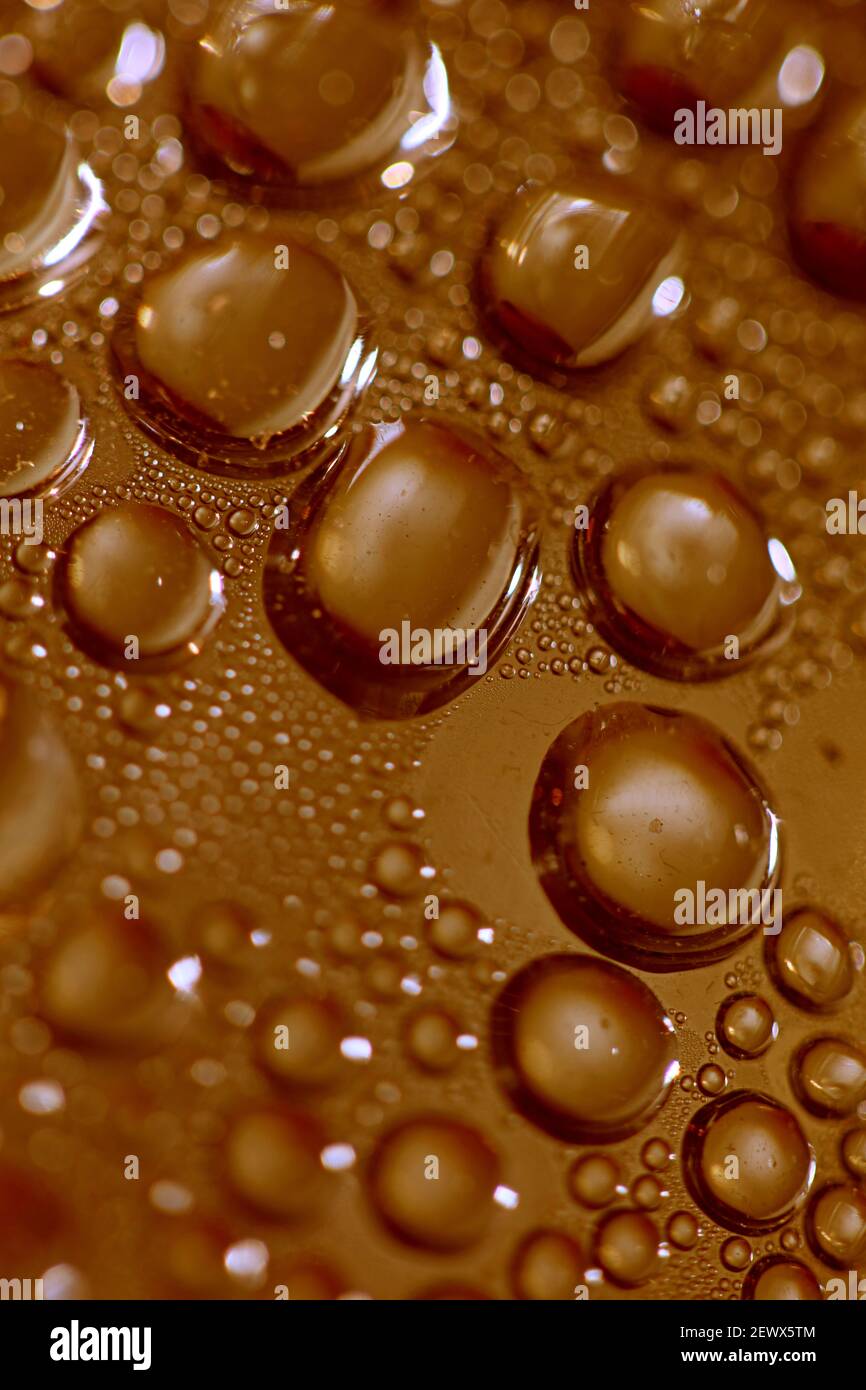 Macro shooting of water droplets beside the glass surface close up ...