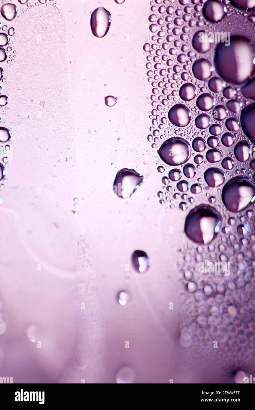 Macro shooting of water droplets beside the glass surface close up liquid drops modern background pattern high quality prints Stock Photo