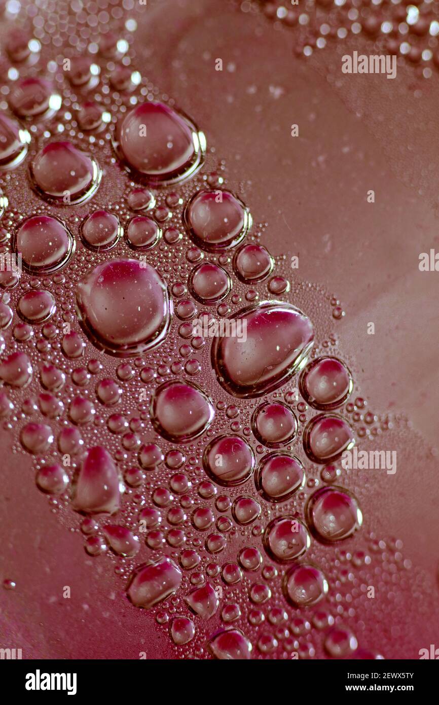 Macro shooting of water droplets beside the glass surface close up liquid drops modern background pattern high quality prints Stock Photo