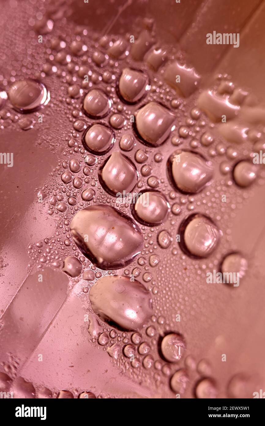 Macro shooting of water droplets beside the glass surface close up liquid drops modern background pattern high quality prints Stock Photo