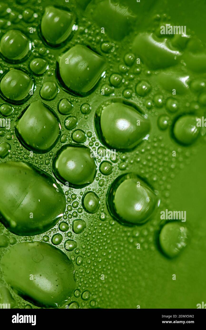 Macro shooting of water droplets beside the glass surface close up ...