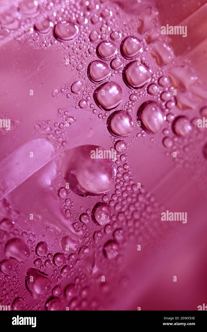 Macro shooting of water droplets beside the glass surface close up ...