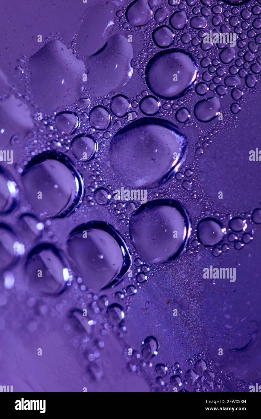 Macro shooting of water droplets beside the glass surface close up ...