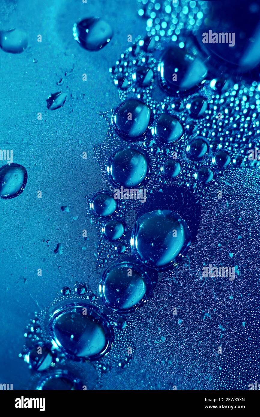 Macro shooting of water droplets beside the glass surface close up liquid drops modern background pattern high quality prints Stock Photo
