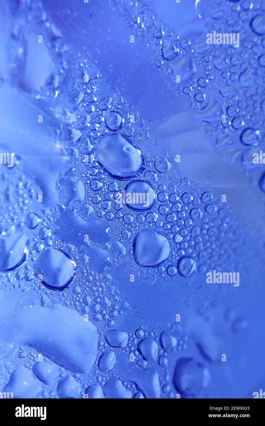 Macro shooting of water droplets beside the glass surface close up ...