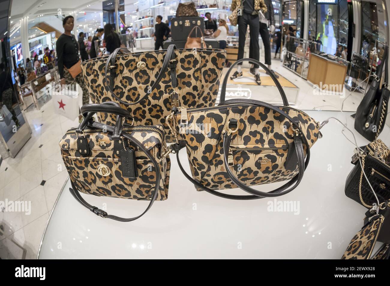 Shoppers browse Coach handbags in the Macy's Herald Square flagship store  on Sunday, March 26, 2017. Tapestry, the owner of the Coach and Kate Spade  brands, announced that revenue per handbag rose