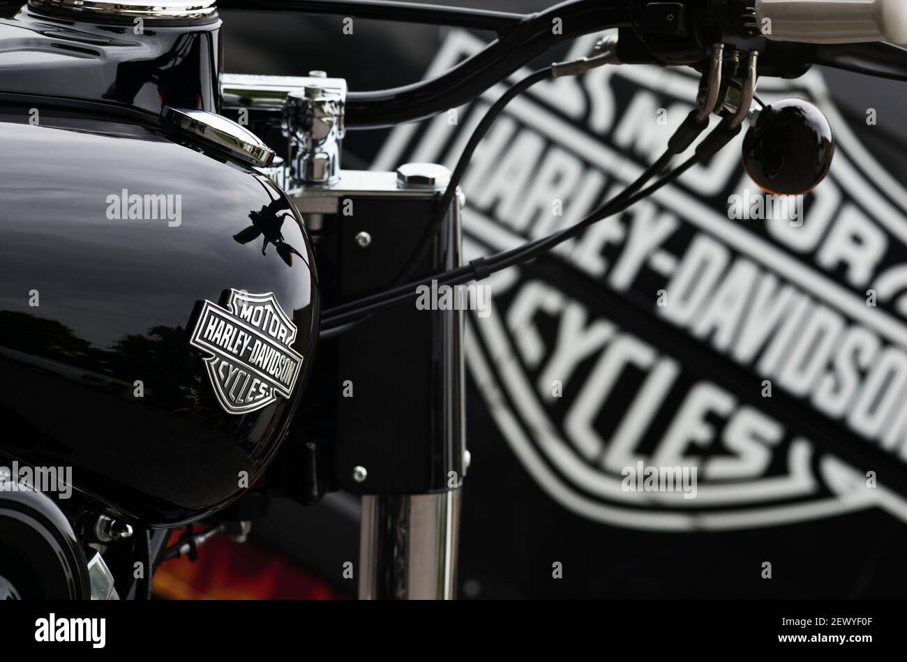 Harley Davidson motorcycle in front of van with Harley Davidson logo Stock Photo
