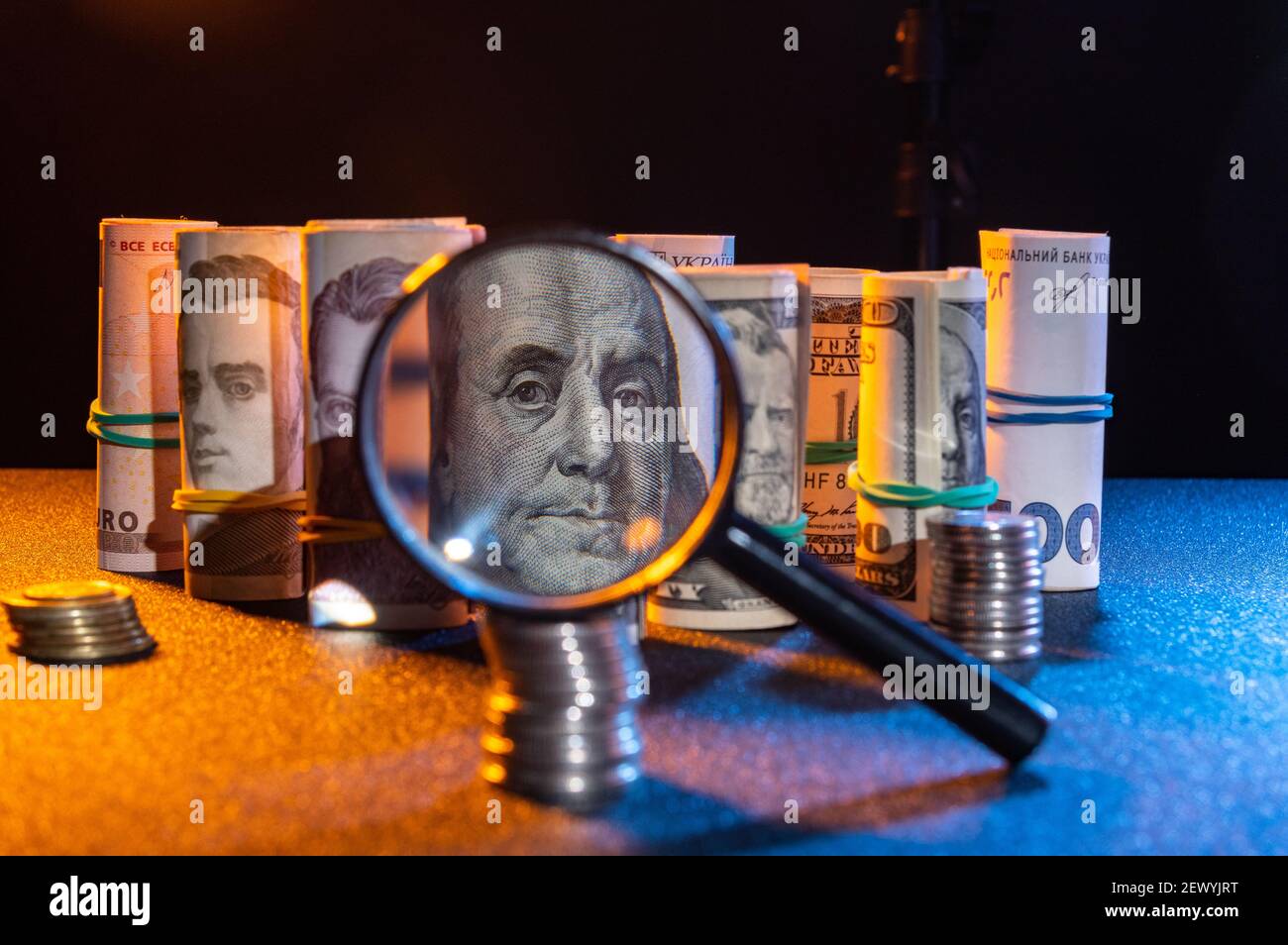 Checking money for falsity. Examining money through a magnifying glass