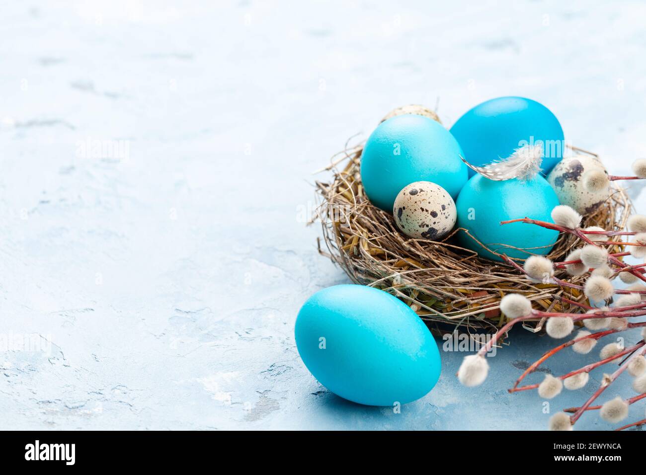 Colorful easter eggs in nest on stone background. With space for your ...