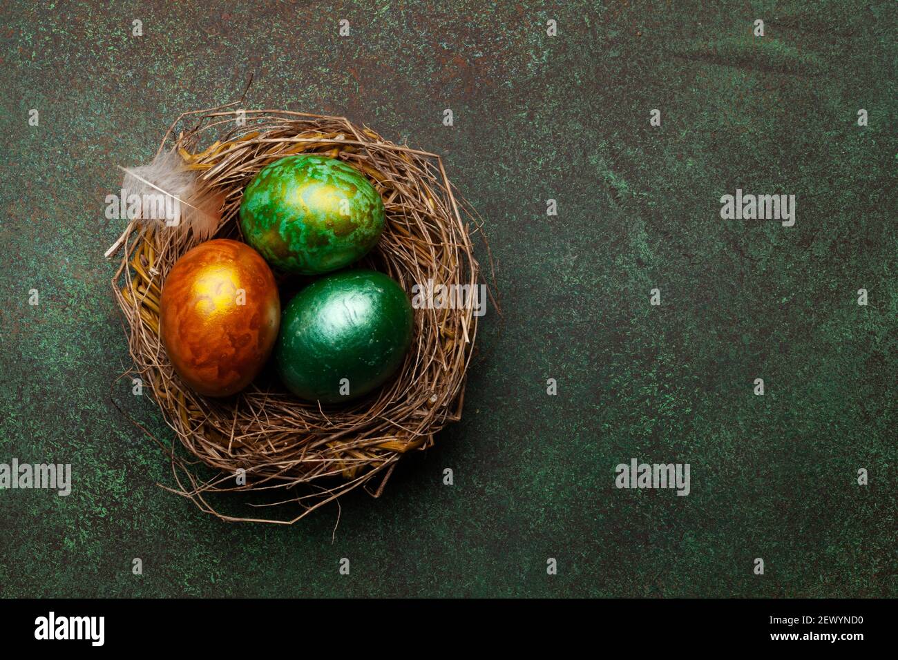 Colorful easter eggs in nest on stone background. Top view. with space ...