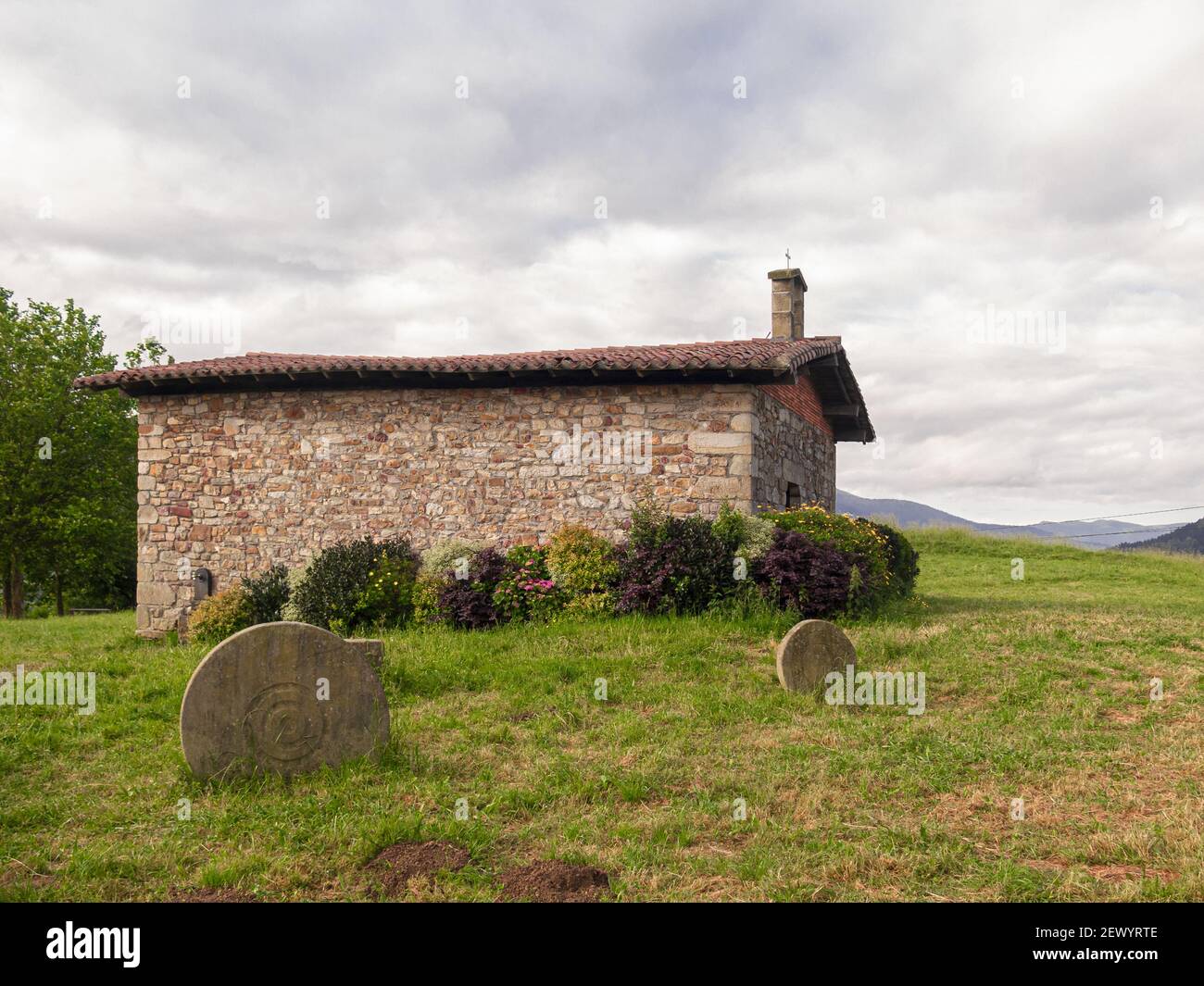 An old stone house on a green meadow Stock Photo - Alamy