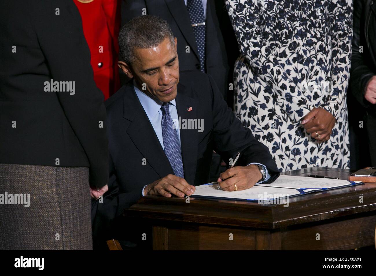 President Barack Obama, joined by First Lady Michelle Obama, signs the Clay Hunt Suicide Prevention for American Veterans Act in the East Room of the White House in Washington, D.C. on February 12, 2015. Photo Credit: Kristoffer Tripplaar/ Sipa USA *** Please Use Credit from Credit Field *** Stock Photo
