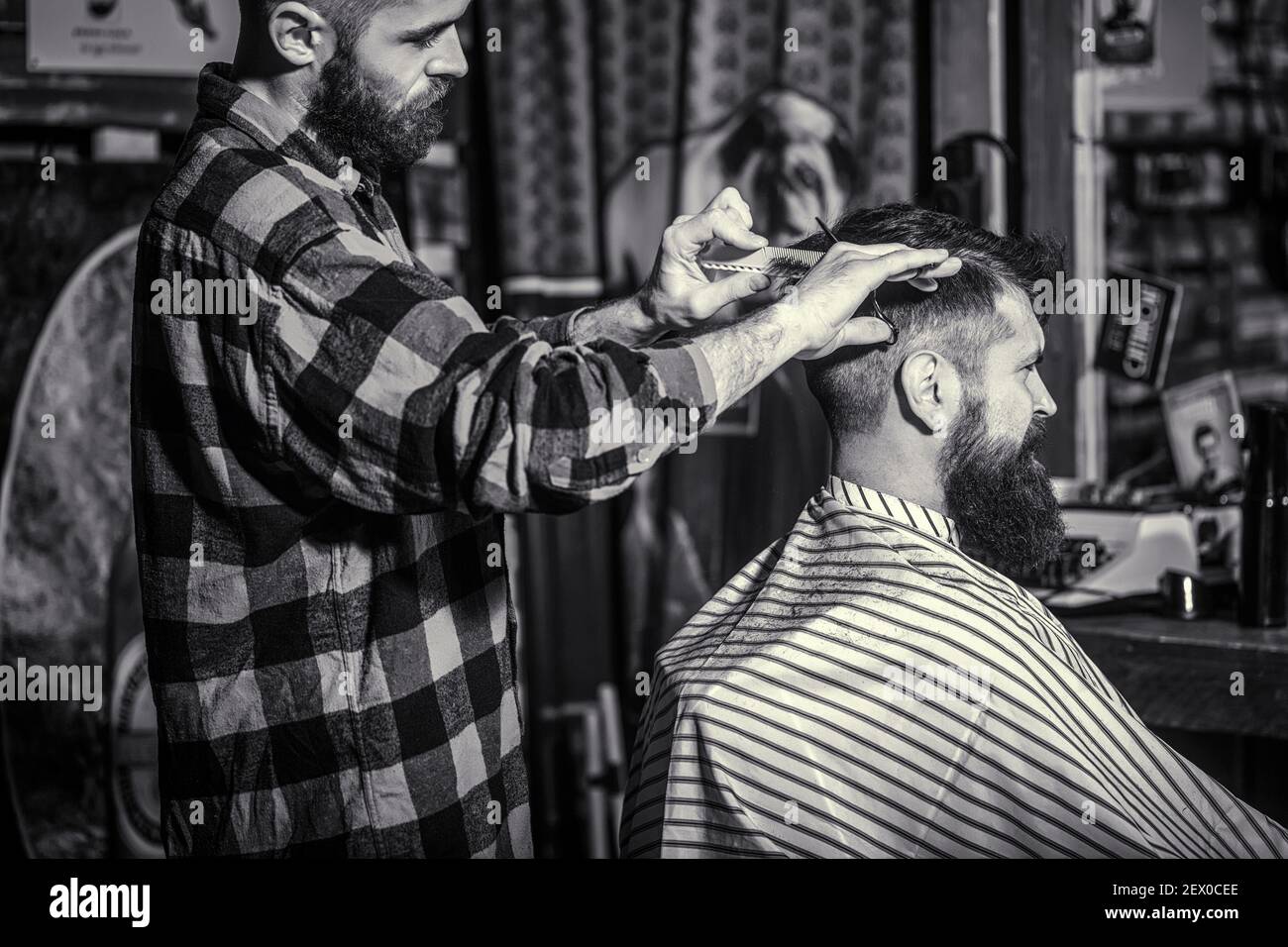 Man visiting hairstylist in barbershop. Barber scissors. Black and white.  Bearded man in barber shop Stock Photo - Alamy