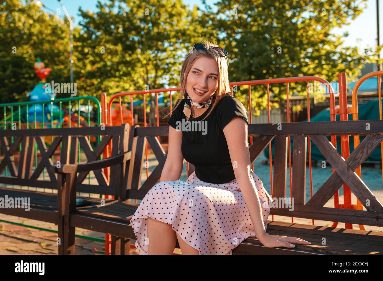 Summer vacation. Portrait of a beautiful young woman is sitting on a ...