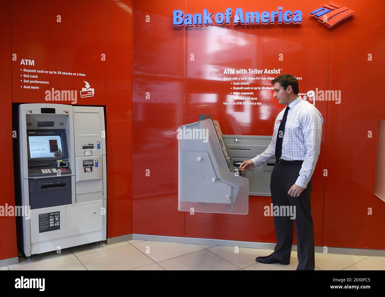 Adam Williams, Bank of America Epicentre financial center manager, demonstrates the ATM with