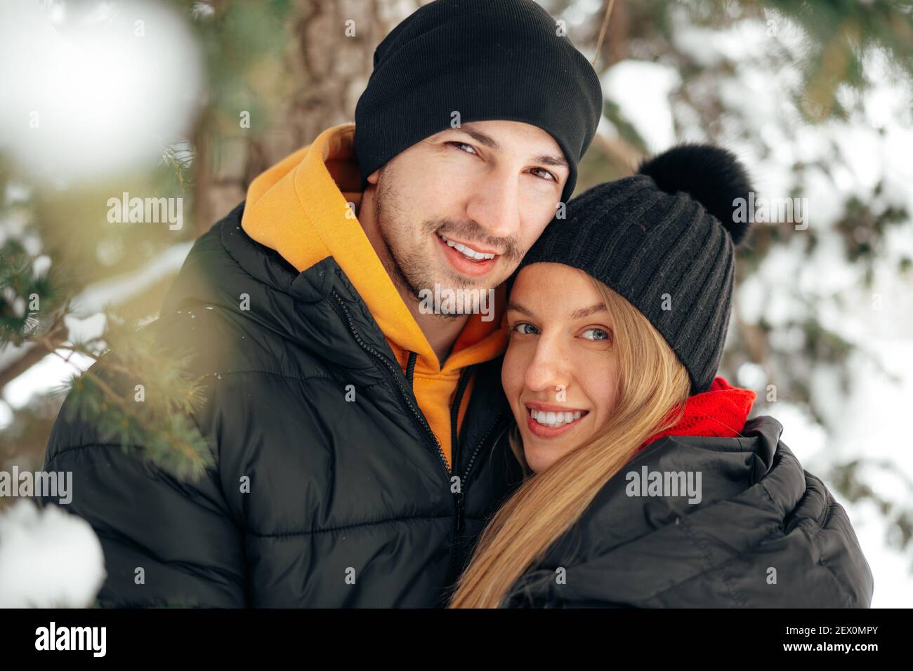 Happy couple hugging and smiling outdoors in snowy park Stock Photo - Alamy