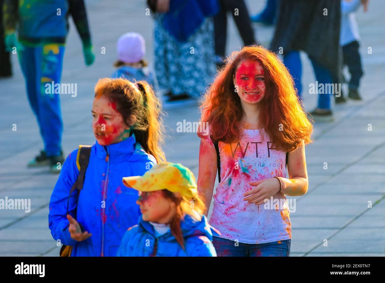 Russia, Moscow - June 25, 2017. Portrait of a girl with bright flowers on her face. Laughs with happiness. Holi is a traditional holiday in India Stock Photo