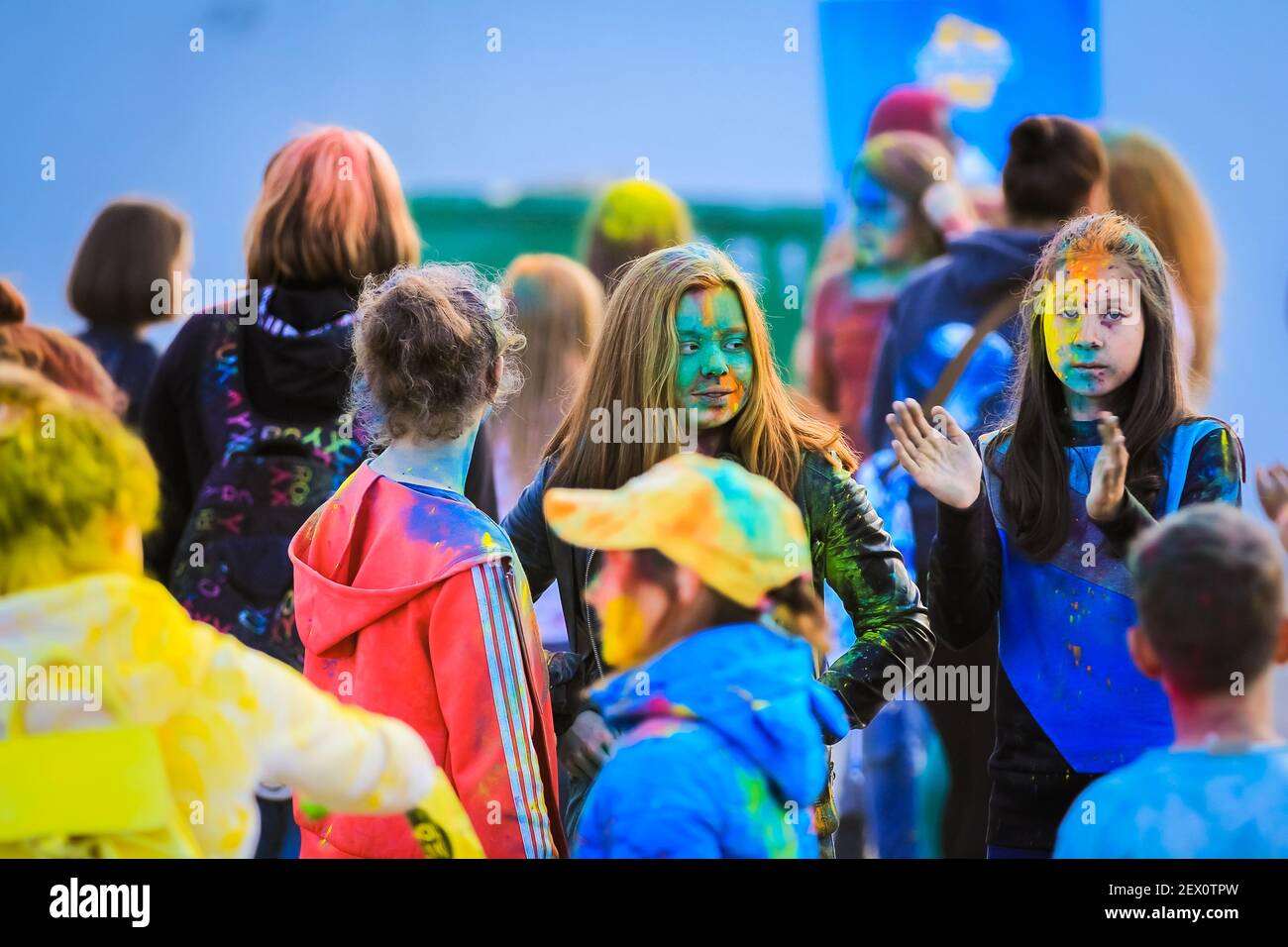 Russia, Moscow - June 25, 2017. Portrait of a girl with bright flowers on her face. Laughs with happiness. Holi is a traditional holiday in India Stock Photo