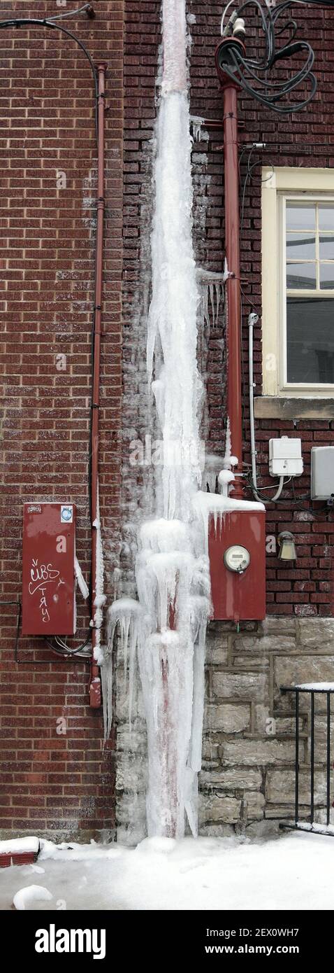 Ice forms from a downspout in Lexington, Ky., on Saturday, Feb. 21, 2015, as the third winter storm of the week to crosses Kentucky. (Photo by Charles Bertram/Lexington Herald-Leader/TNS) *** Please Use Credit from Credit Field *** Stock Photo