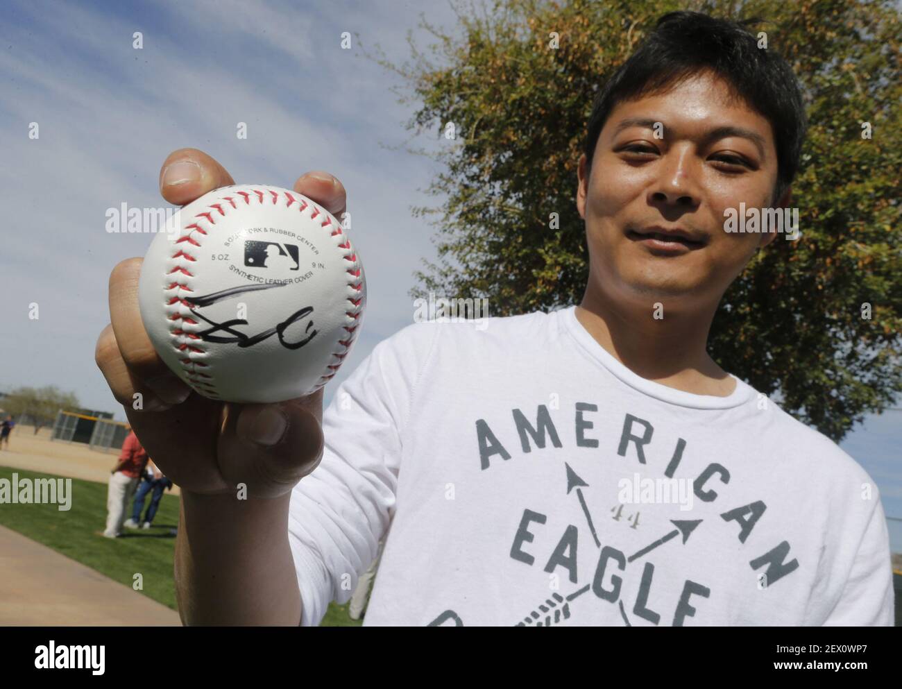 Texas Rangers fan Masahiro Sakashita, of Japan, shows off his Yu