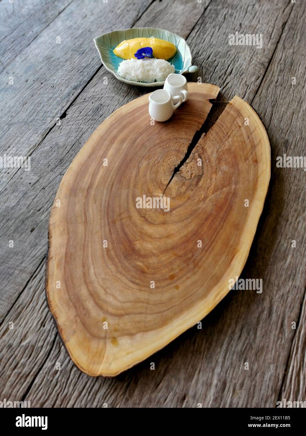 sticky rice and mango, huge wooden tray with two milk cups on wood ...