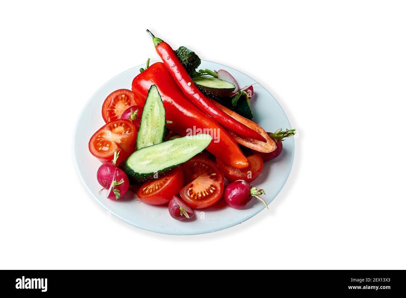slicing fresh vegetables on a plate Stock Photo