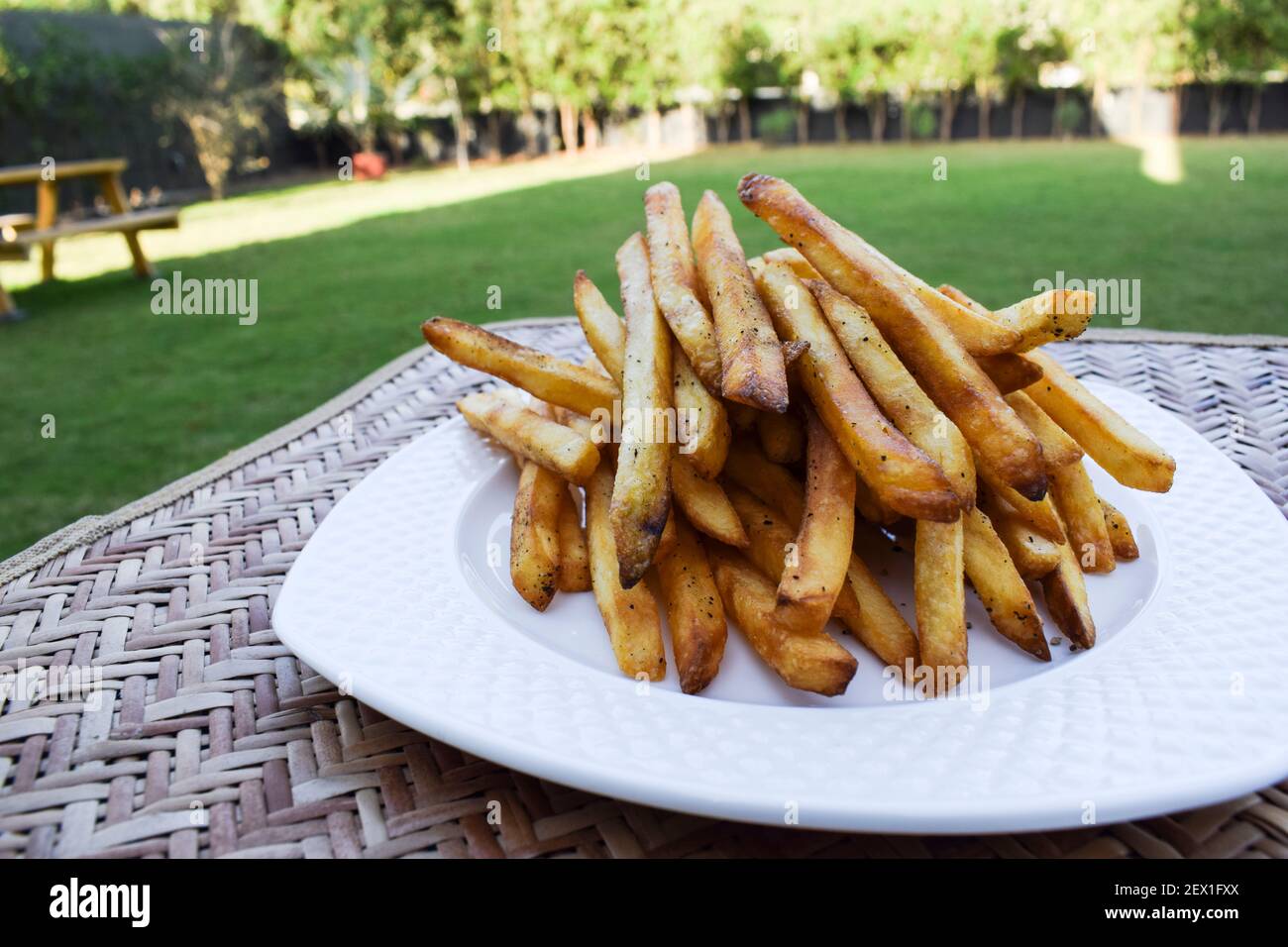 Crispy crunchy French fries heap. Potato finger chips with seasoning