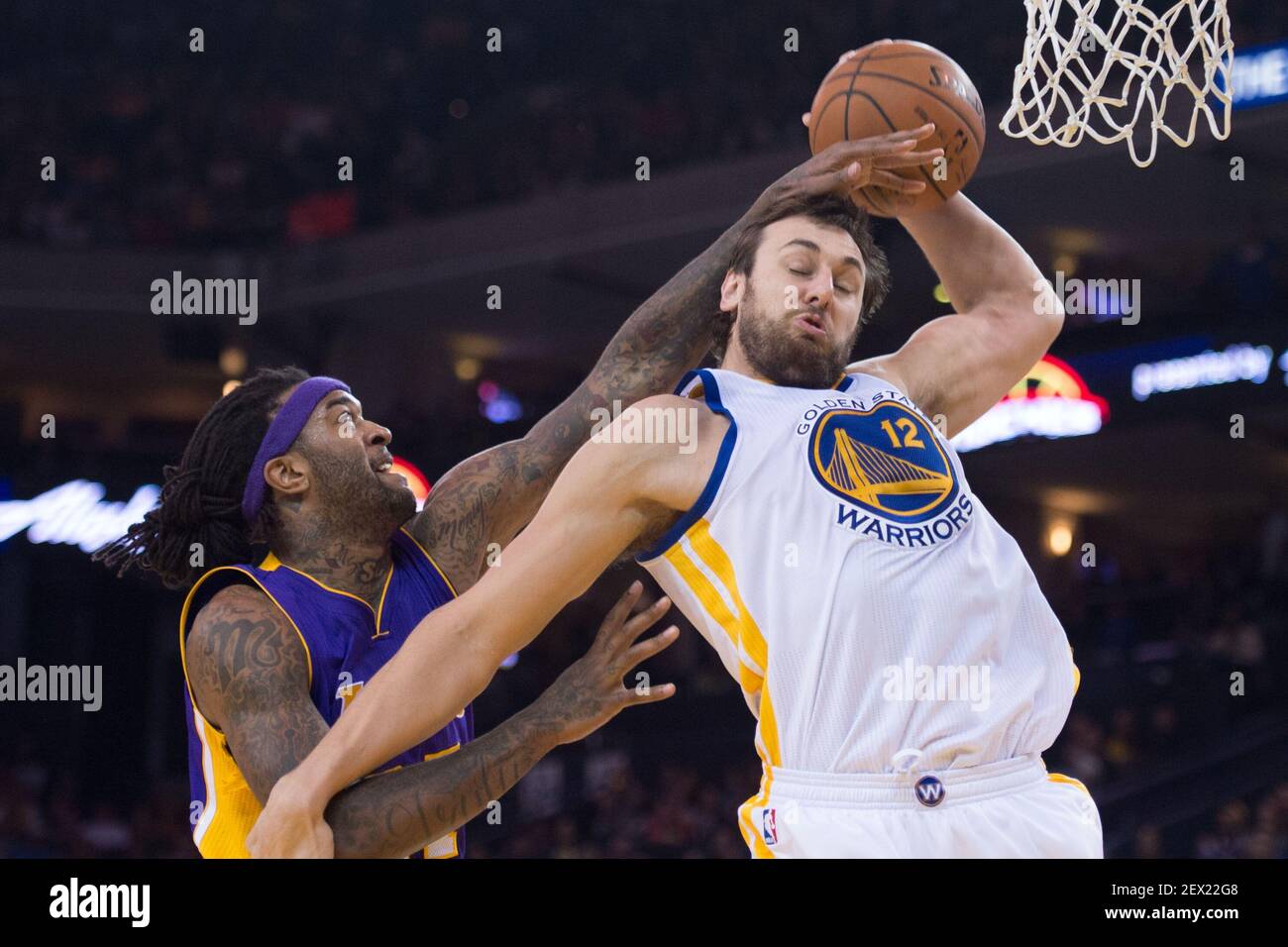 March 16, 2015; Oakland, CA, USA; Golden State Warriors center Andrew Bogut  (12) grabs a rebound against Los Angeles Lakers center Jordan Hill (27)  during the second quarter at Oracle Arena. Mandatory