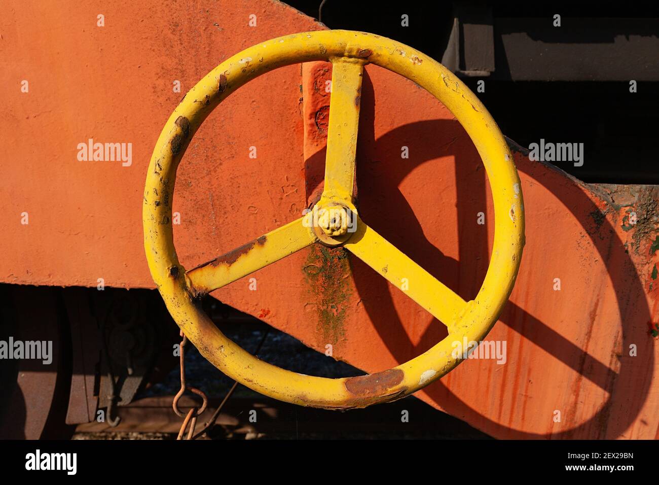 Yellow metal hand wheel, old and rusty Stock Photo