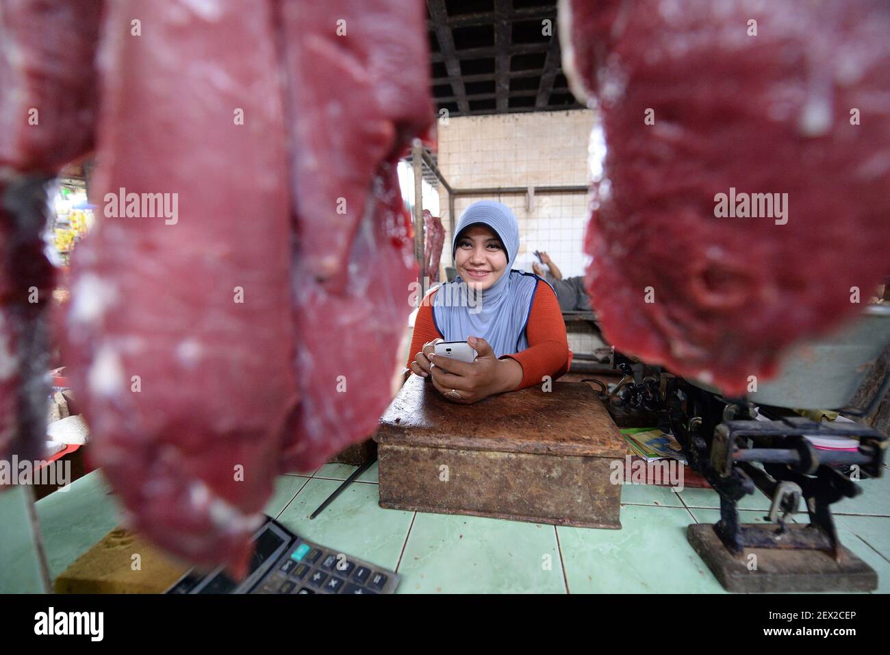 Meat vendor waits for customers at the Pucang market in Surabaya