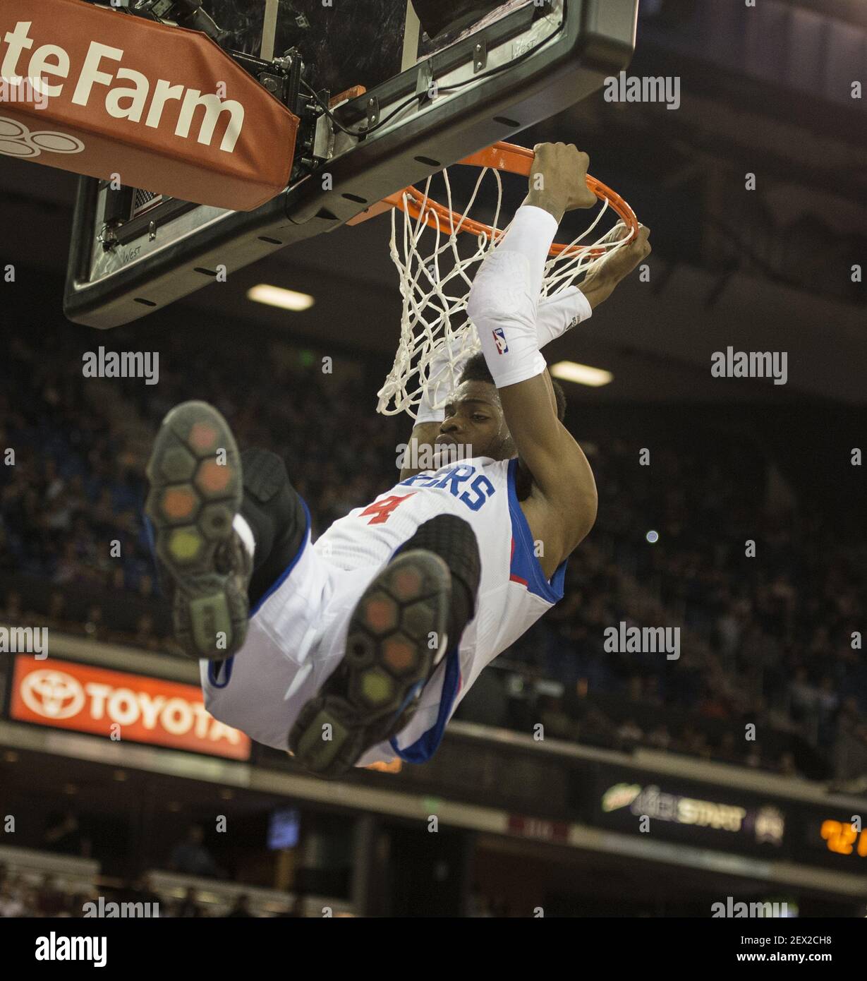 Philadelphia 76ers center Nerlens Noel (4) swings from the rim after dunking  a ball in the first quarter on Tuesday night, March 24, 2015 in the NBA  game between the Sacramento Kings