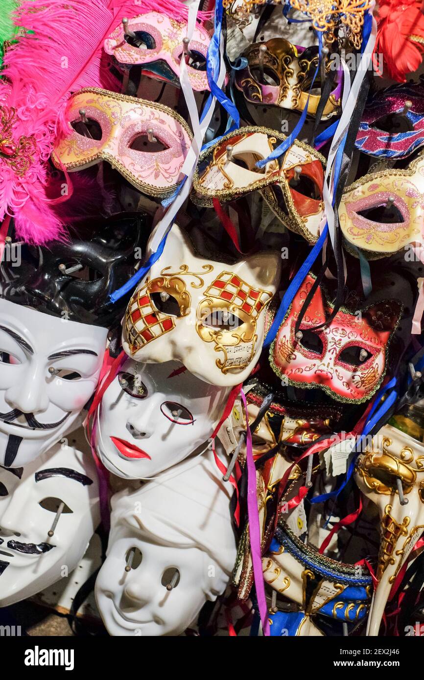 Rack of different types of Venetian Masquerade Masks, carnival masks on sale in Venice, Italy Stock Photo