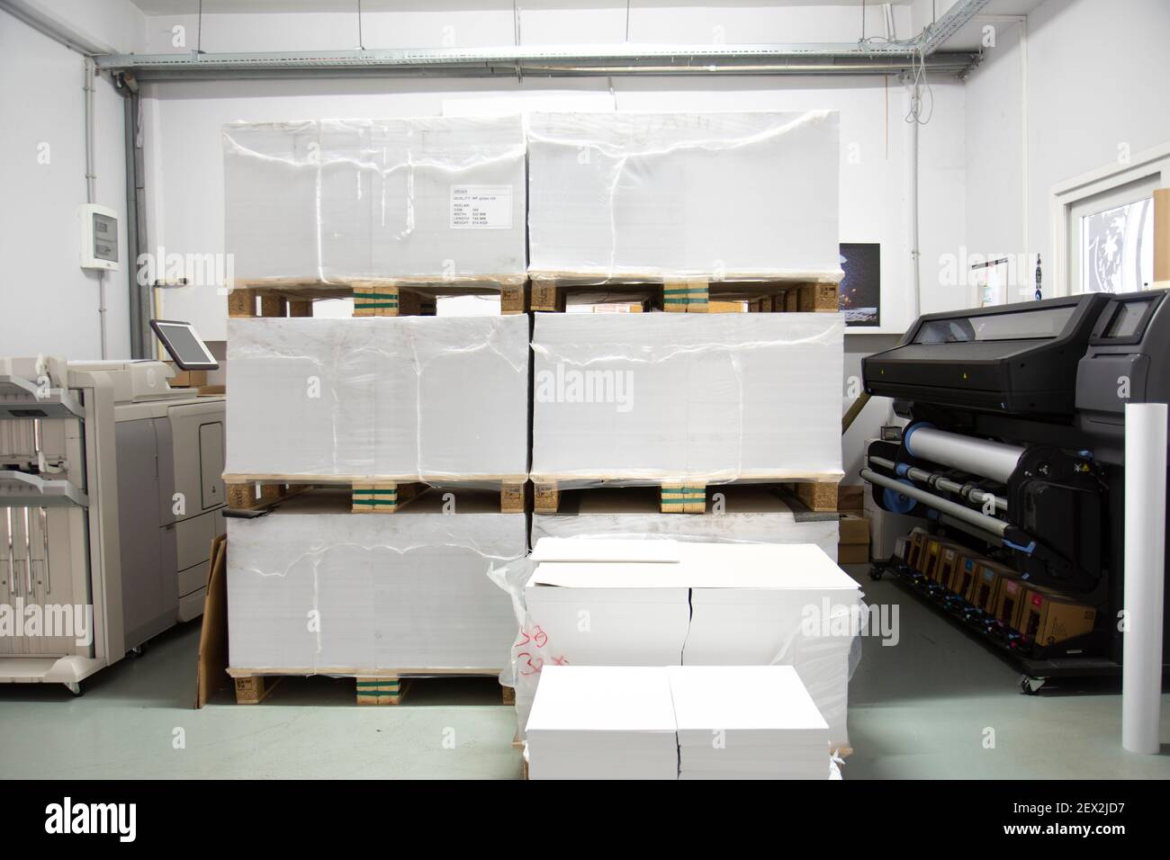 pallets stacked on top of each other and digital printing machines are intertwined. Stock Photo