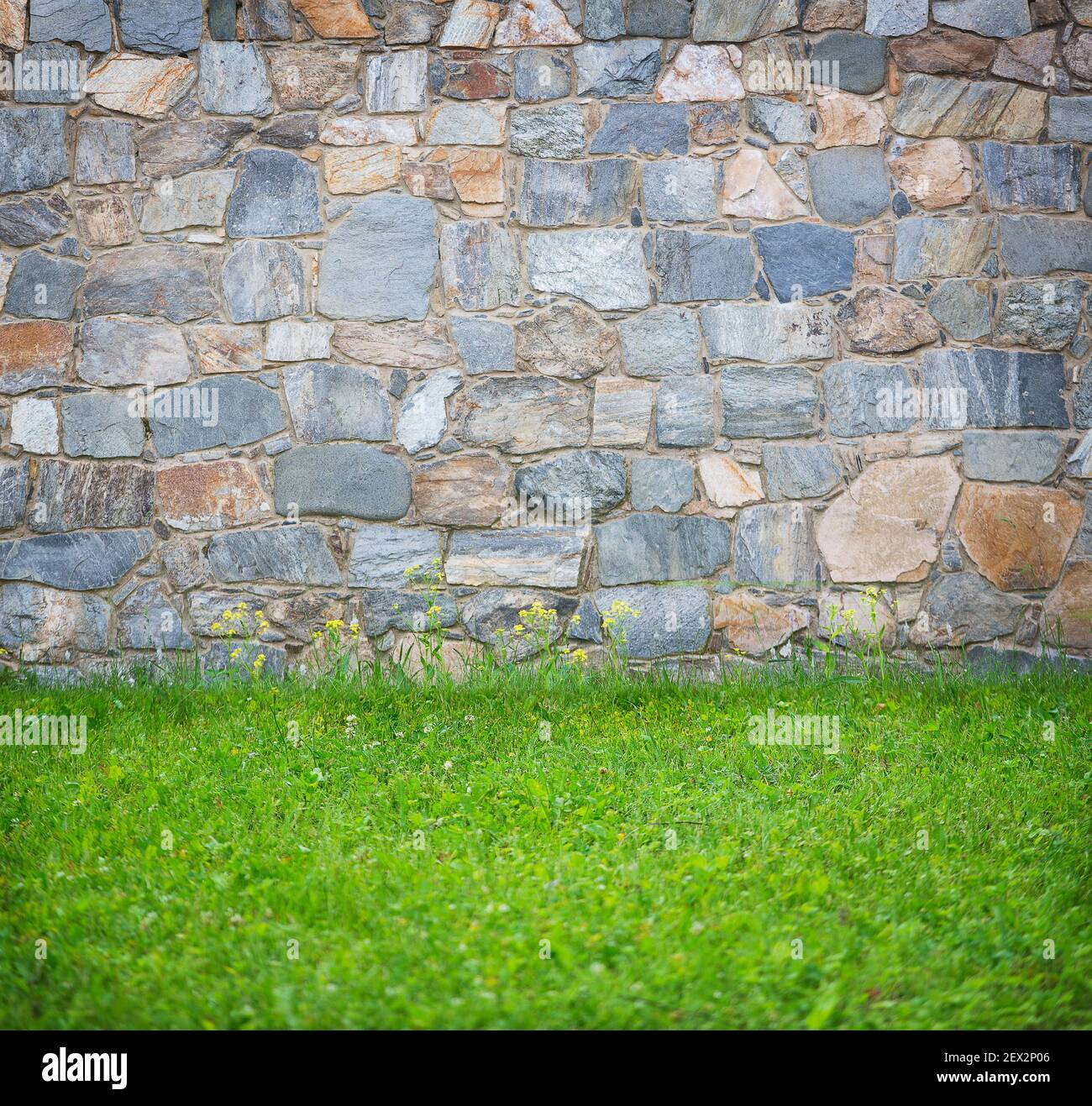 background old stone wall and grass Stock Photo - Alamy