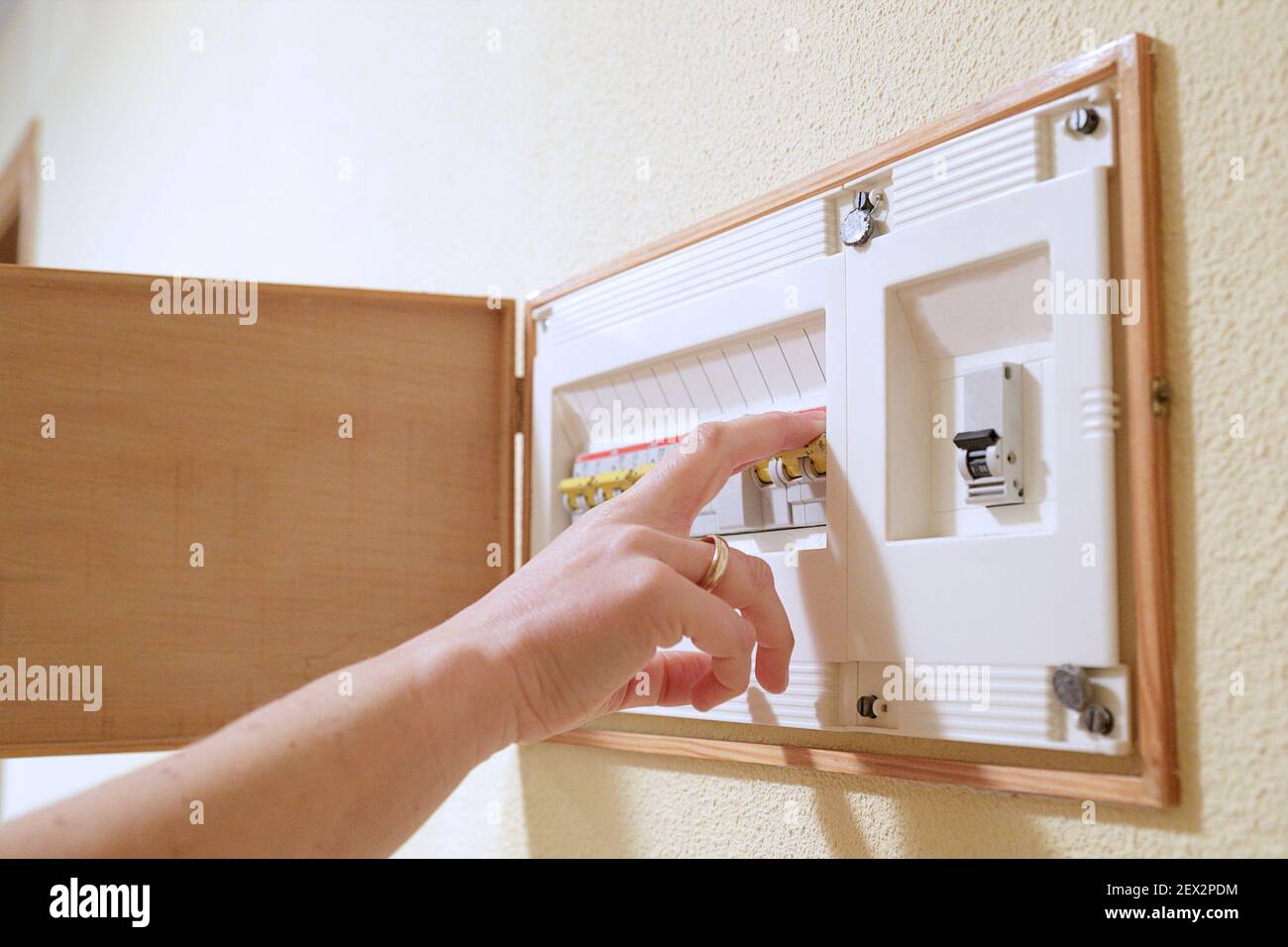Woman hand turning off fuse box in the house Stock Photo Alamy