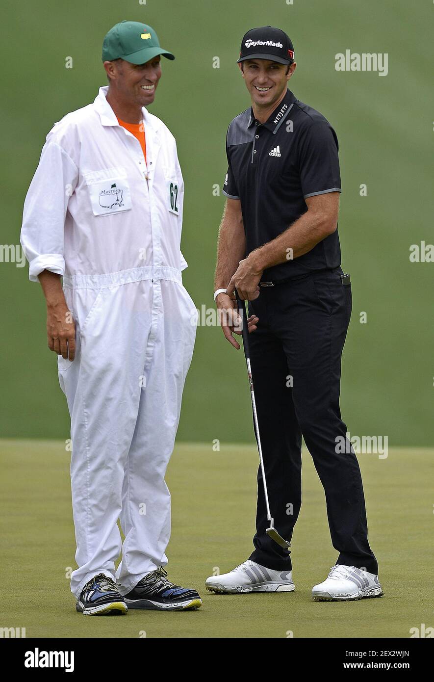 Caddie Jim "Bones" Mackay, left, and golfer Dustin Johnson, right, joke