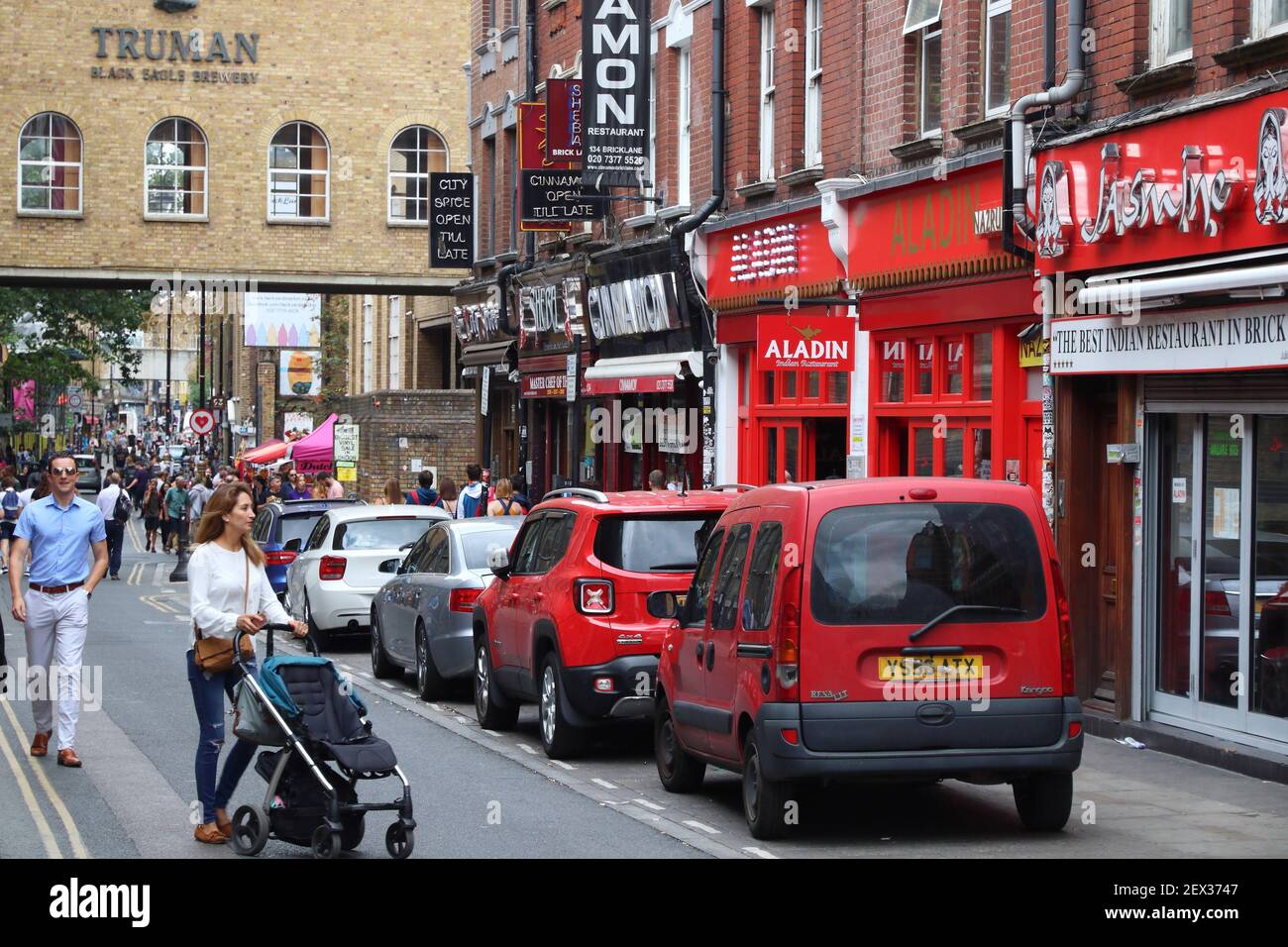 LONDON, UK - JULY 13, 2019: People visit Brick Lane street in Shoreditch district of London. Shoreditch is known for its multicultural community. Stock Photo