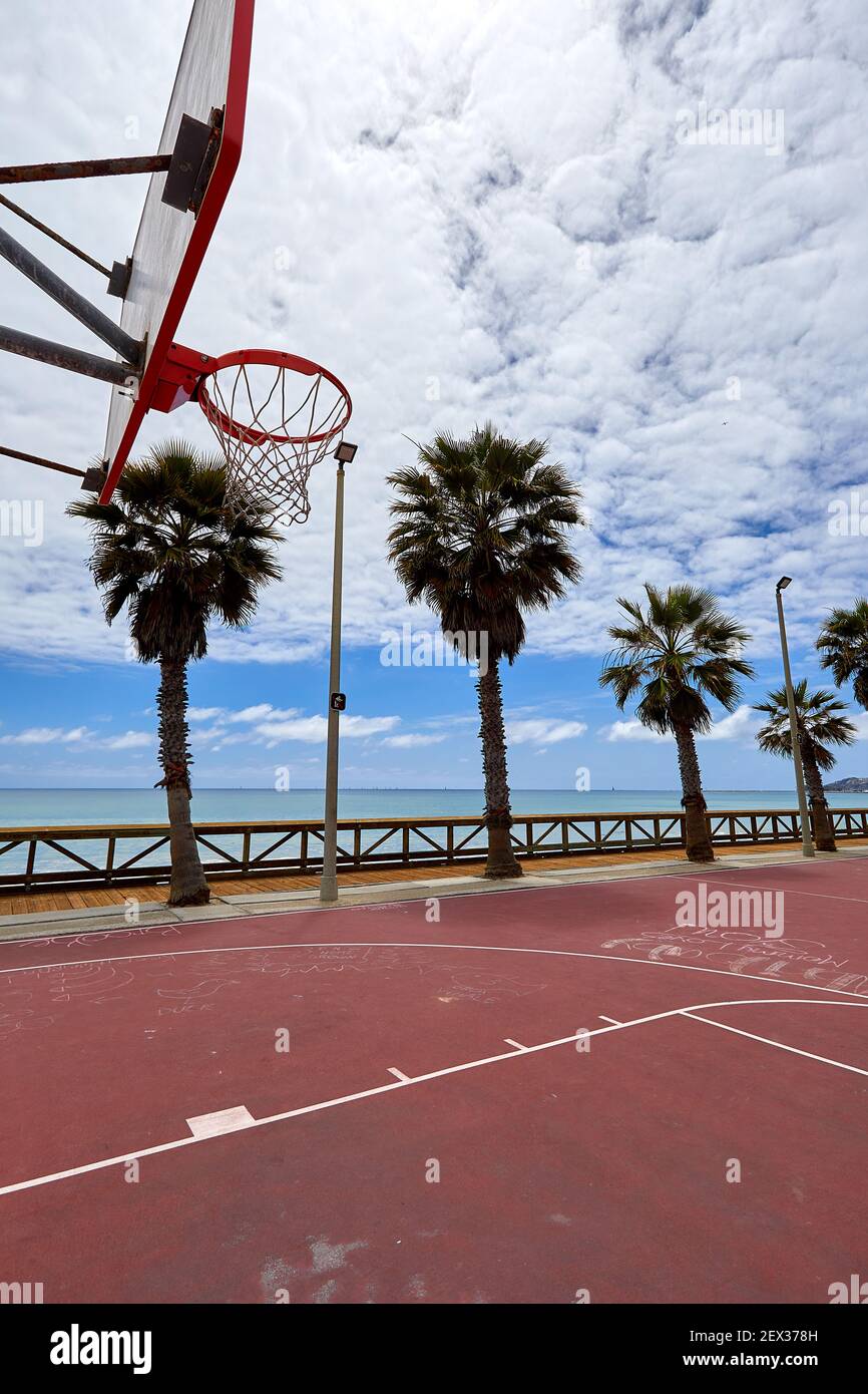 Outdoor street basketball court on beach in San Clemente California with  orange surface and palm trees in the background showing hoop and backboard  Stock Photo - Alamy